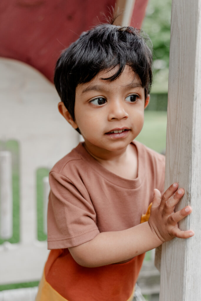 Junge zeigt neugieriges Gesicht beim Entdecken im Garten